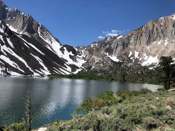 Snow-dusted mountain peaks reflecting in the calm waters of Convict Lake